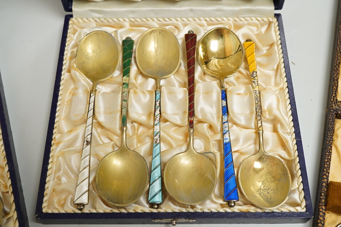 An Edwardian silver elliptical shaped inkstand, with two mounted glass wells and central pen wipe, James Dixon & Sons, Sheffield, 1906, together with ten Danish sterling and polychrome enamel spoons(a.f) and a cased set